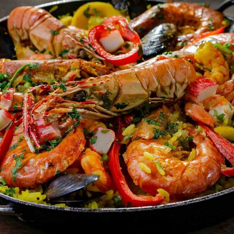 Paella is a rice dish originally from the Valencian Community. Paella is regarded as one of the community's identifying symbols. It is one of the best known dishes in Spanish cuisine.